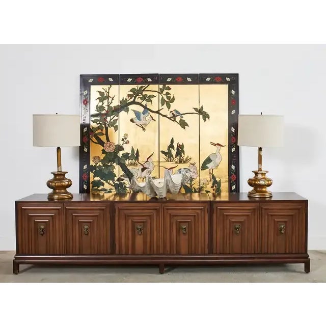Dazzling Chinese export lacquered four-panel coromandel screen featuring a flora and fauna waterscape with stylized...