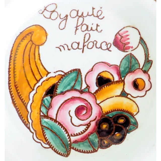 Fun, colorful promotional ashtray from the beloved Le Bon Marche retailer. The central image is of a cornucopia of fruits...