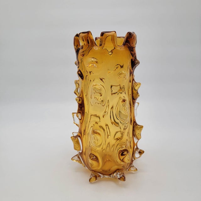This vintage Barovier & Toso Murano art glass vase features a striking amber tone and intricate textured details. Its...