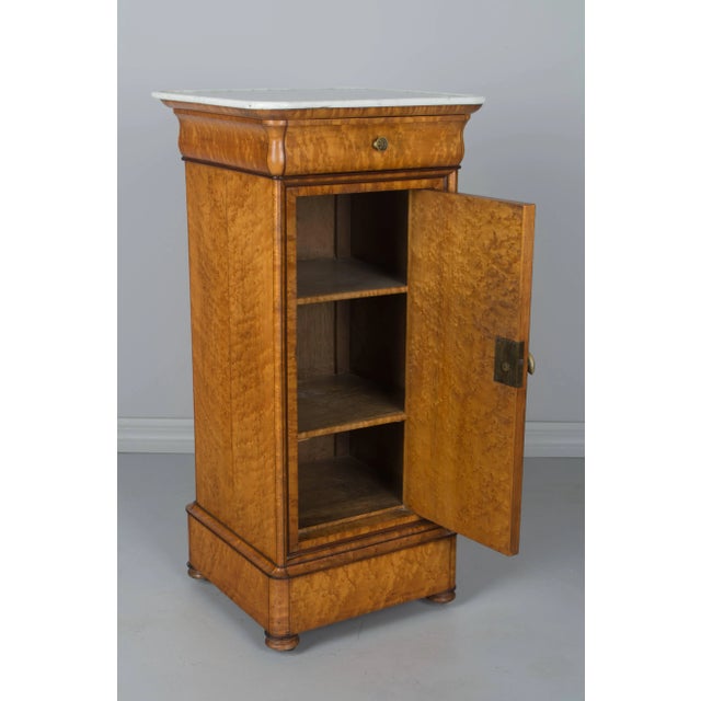 A 19th century French Charles X Period side table or nightstand, made of veneer of bird's-eye maple over solid oak...