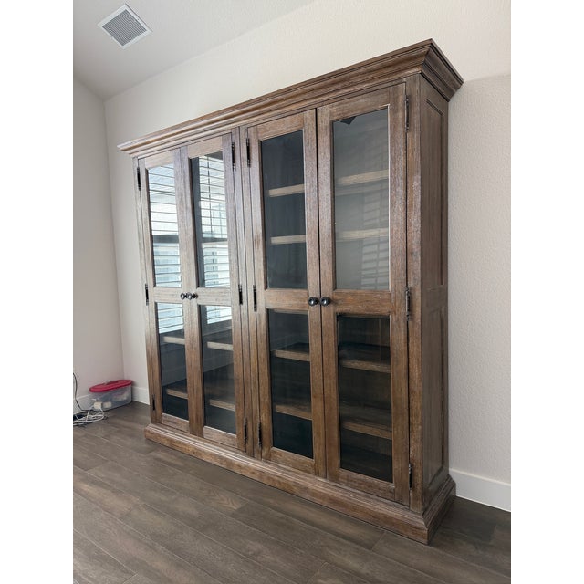 Large double bookcase with glass doors, crown and base units. From the Bassett Furniture Compass collection, in Western...