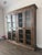 Large double bookcase with glass doors, crown and base units. From the Bassett Furniture Compass collection, in Western...
