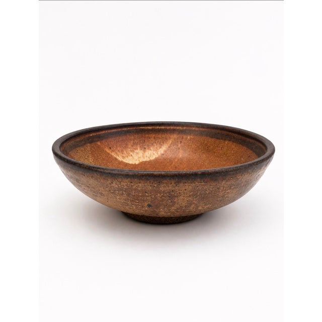 Handcrafted studio pottery stoneware bowl with a wide, low form and beautifully earthy glaze in warm brown, rust, cream...