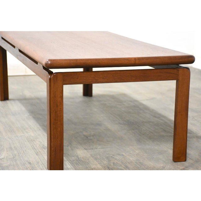 A mid century modern teak coffee table. Circa 1960’s. Made in Denmark. Professionally refinished. 53” wide. 22” deep. 16”...