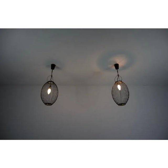 This striking pair of mid-century pendant lamps from italy, dating back to the 1960s, showcases the era's refined blend of...