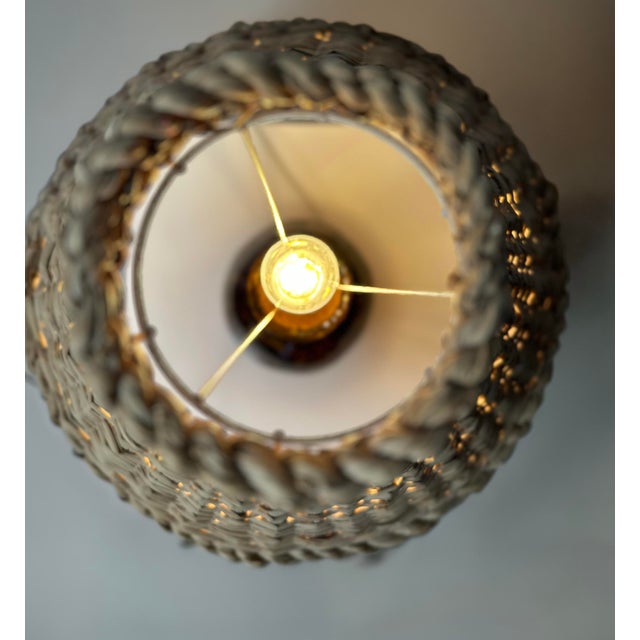 This vintage ceramic mid-century table lamp features a sculptural, handmade base with authentic period charm, topped with...