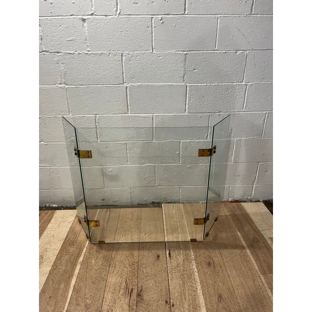 Superb clear glass fire screen by Jacques Adnet made in 1970 in France. Three Panel tempered Glass with Brass Hardware....