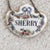 A set of three antique liquor bottle decanter tags. Each tag is created from fine porcelain in a medallion shape. On a...