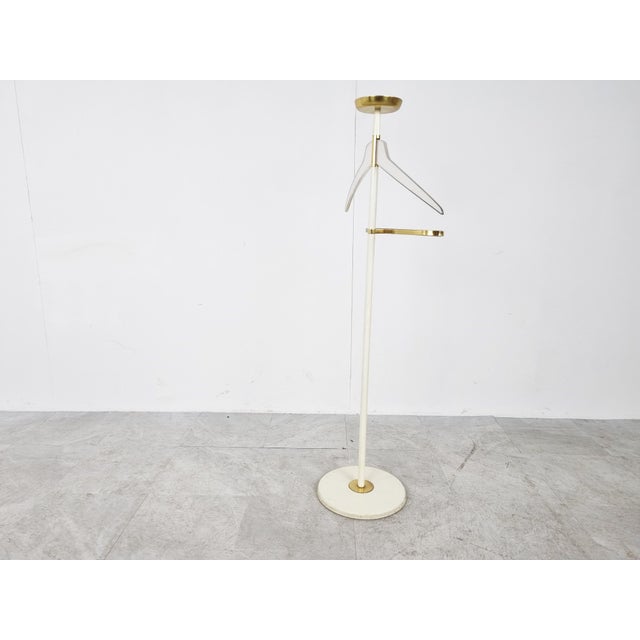 Mid-Century clothes valet/dressboy made by Vereinigte Werkstätten. It is made from a white enamelled frame, a brass and...