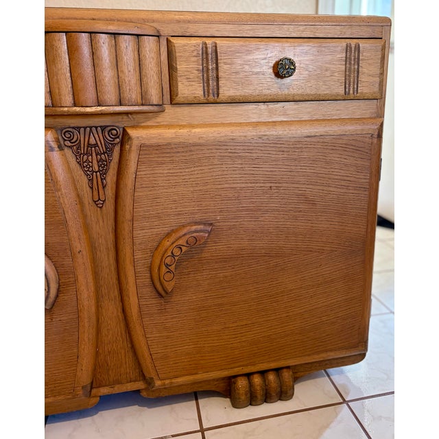 Inspire bold character with a striking and highly decorative 1930s English oak sideboard attributed to Jentique-...