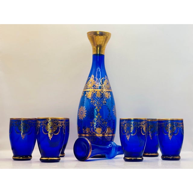 Decanter measures 11 1/2 inches tall, 2 1/4 inches at the foot, 3 at its widest point and 2 at its opening. Glasses...