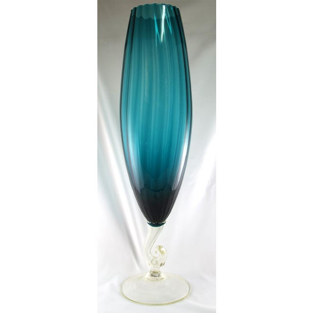 Early 1960s blue-green fluted art glass vase with clear glass stand. Estate item purchased by the original owner. It would...