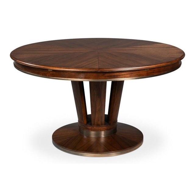 A broad circular top and flared pedestal give the table a composed, sculptural presence. The broad circular top and rich...