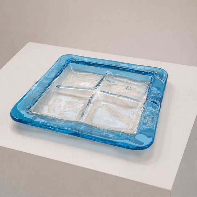 An elegant blue Murano glass emptier, decorative tray, or centerpiece, produced by Venini in the 1970s. The piece features...