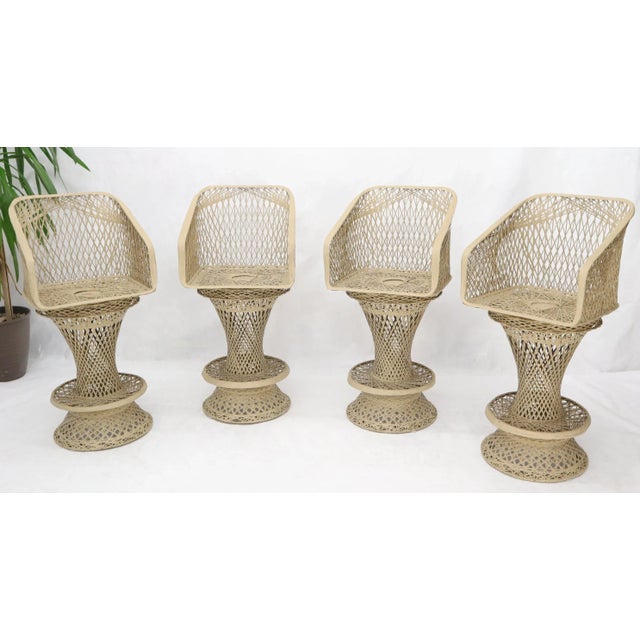 Mid-Century Modern set of four Russel Woodard bar stools.