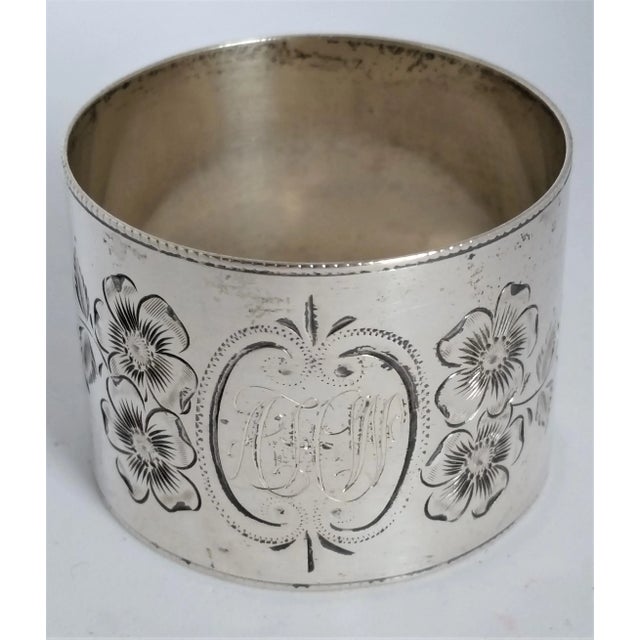 Add timeless elegance to your table setting with this antique sterling silver napkin ring, featuring exquisite hand-...