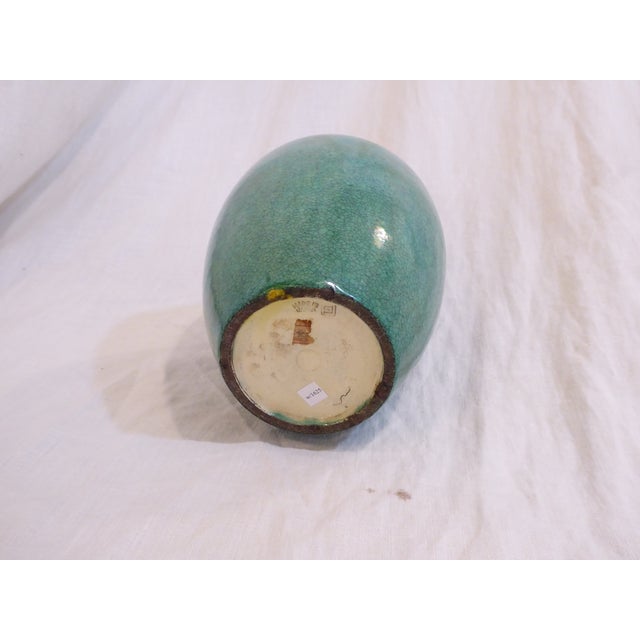 This Japanese vase has a crackled green glaze and is marked, made in Japan on the underside.