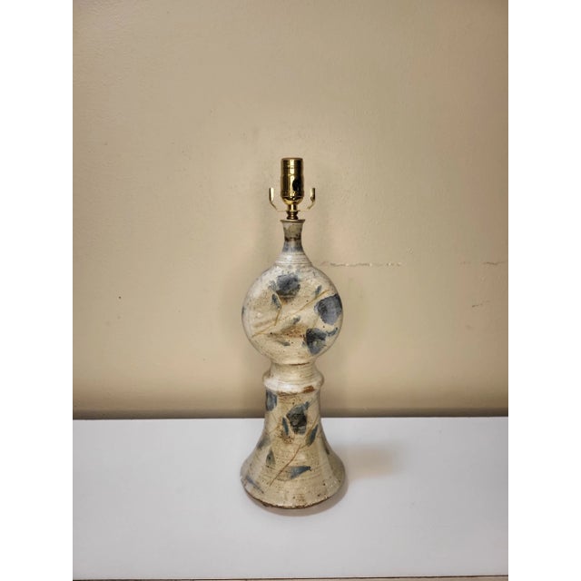 Blue details and a pitched white linen shade, yes please. This Danish piece boasts soft curves and organic features. A...