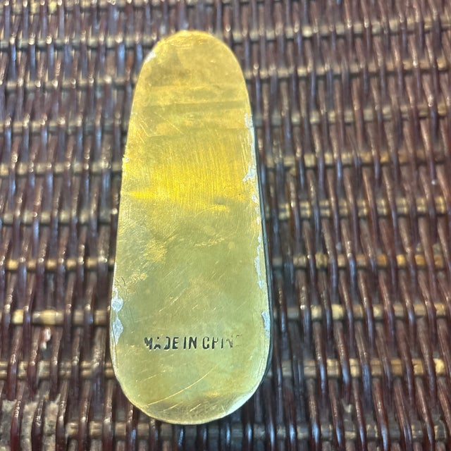 Antique Brass Shoe circa 1920 that would look cute on a stack of books. It has made in China on the sole of the shoe which...