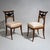 Pair of Biedermeier chairs with upholstered seats and stained beechwood frames. The unusually designed backrests feature...