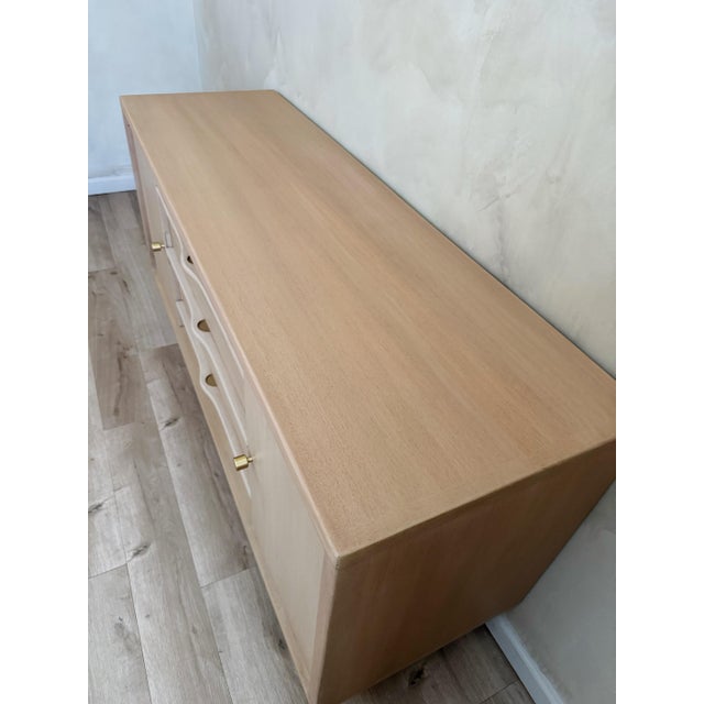 This vintage sideboard has been thoughtfully refreshed with a soft organic modern look. The warm natural wood tones...