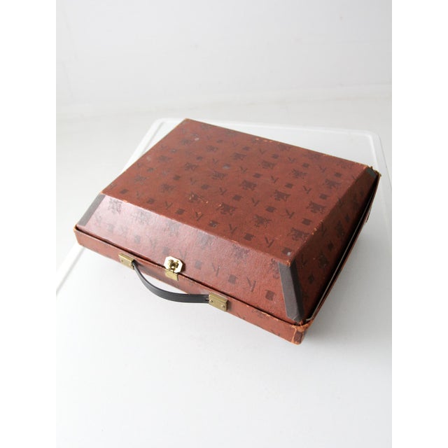 A rare luggage-style top hat box from Knox, designed with a structured silhouette and finished with a repeating Knox logo...