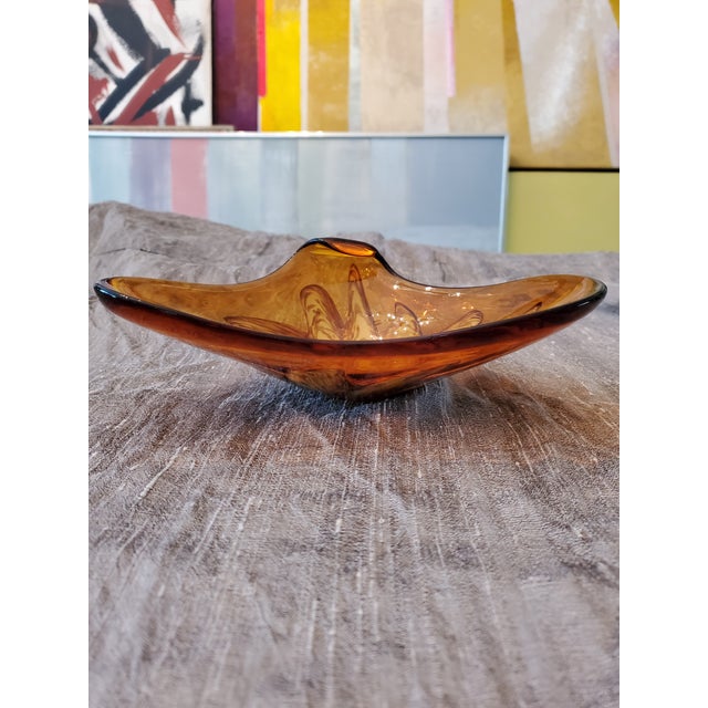 A fine 1960s amber internally decorated murano style diminutive centerpiece. Having a free form abstract shape all hand...