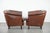 We are offering this unique set of two cognac-colored cowhide club chairs in English style with a luxurious look. This...