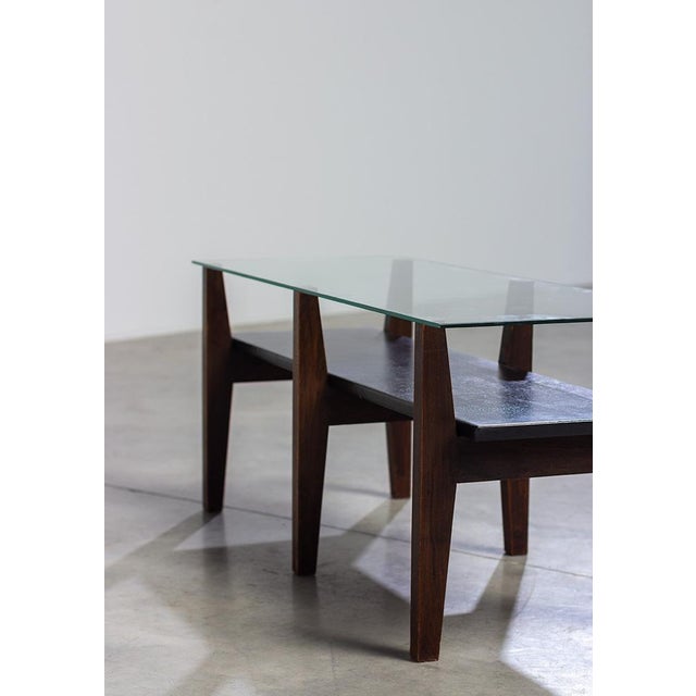 This elegant Belgian coffee table is designed in a strong constructivist 50s style. The wooden walnut legs create a design...