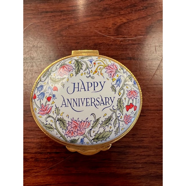 Handpainted enamel box with hinged lid and 24ct gold plated bezels. Lid is floral with Happy Anniversary. Made in England...