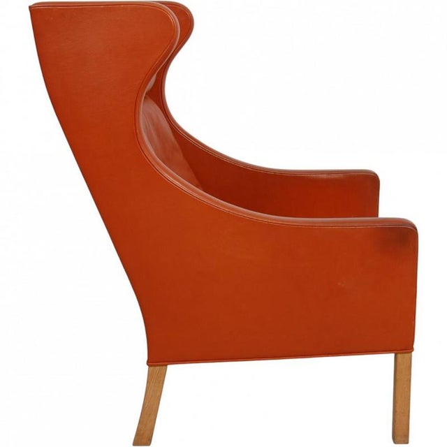 Børge Mogensen wingchair, model 2204, upholstered in original cognac leather and with legs of oak. The chair is from the...