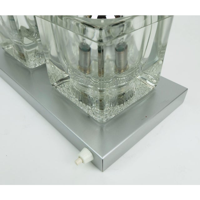 A very beautiful sconce from the 1960s to 1970s by peill & putzler, model no. 71056. The base is made of brass with a...