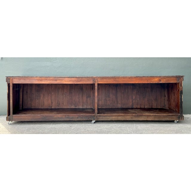 This vintage industrial long counter commands attention with its expansive 126-inch span, framed in wood with...