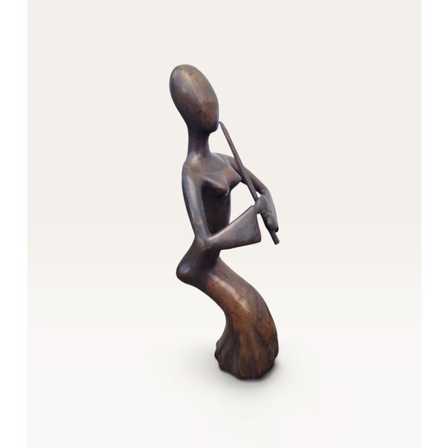 A striking French solid bronze sculpture depicting an elegant female musician playing the flute. Originating from France...