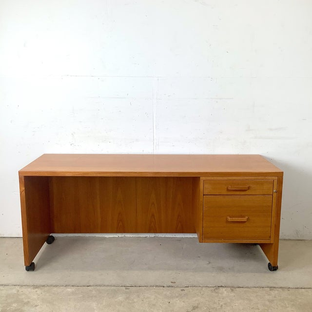 Embrace the timeless elegance of Scandinavian design with this vintage Danish Modern teak executive desk. Exhibiting the...