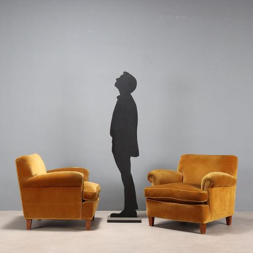 A pair of vintage armchairs with sprung padding, a down cushion, and original period velvet upholstery. These seats are...