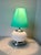 Table lamp in satin white and teal blown glass dating back to the 1990s. Chrome metal details. European Plug (up to...