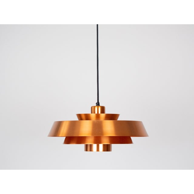 A pair of copper Nova lamps designed by Jo Hammerborg in 1963. When lit, the lamp provides a soft, glare-free downward...