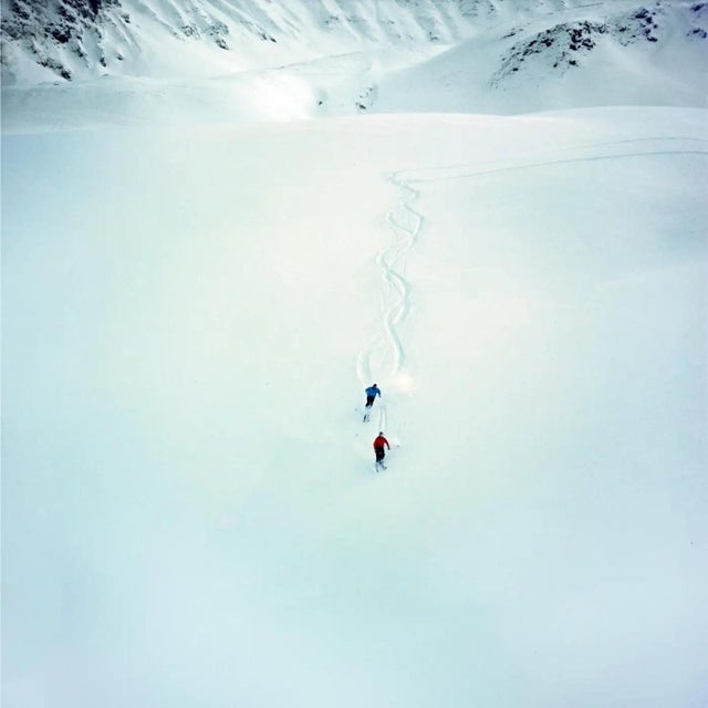 Klosters Ski Scene by Toni Frissell Two skiers ski down a snow covered hill in Klosters Switzerland 1954. (Photo by Toni...