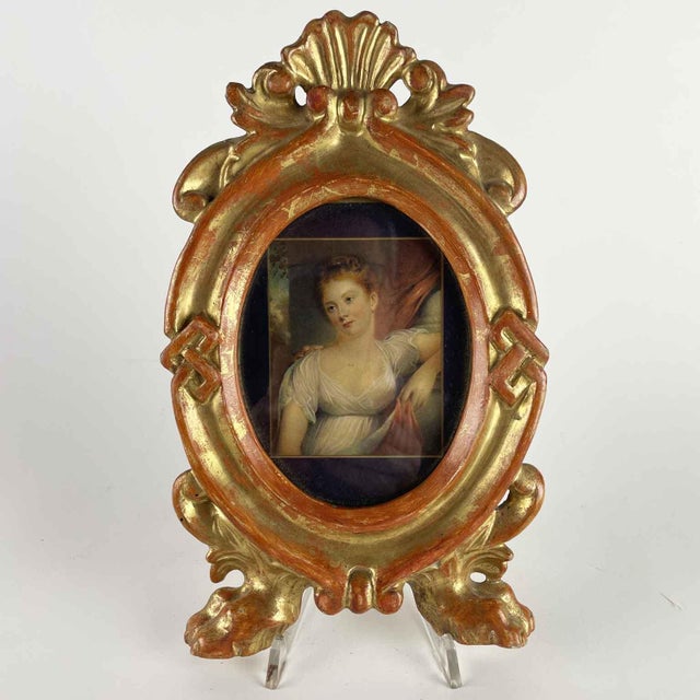 Four antique oval gilded frames with feral feet and a shell-shaped cymatium, and two central decorations consisting of the...