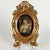 Four antique oval gilded frames with feral feet and a shell-shaped cymatium, and two central decorations consisting of the...