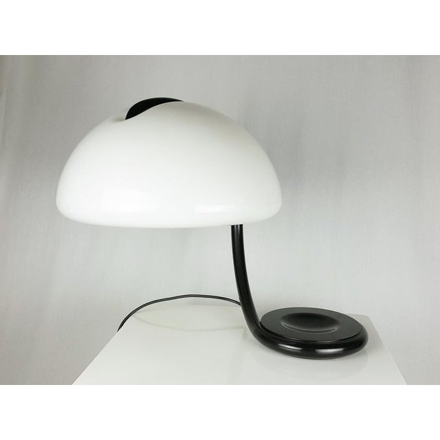 Black metal adjustable base with white plastic shade. Maker label inside the shade and above the base. Very good...