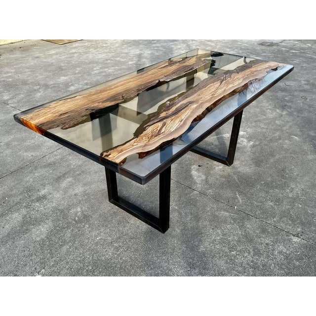 Smoke is a dining table made of wood and epoxy resin. In this River Table two steps of Lecce olive and epoxy resin are...