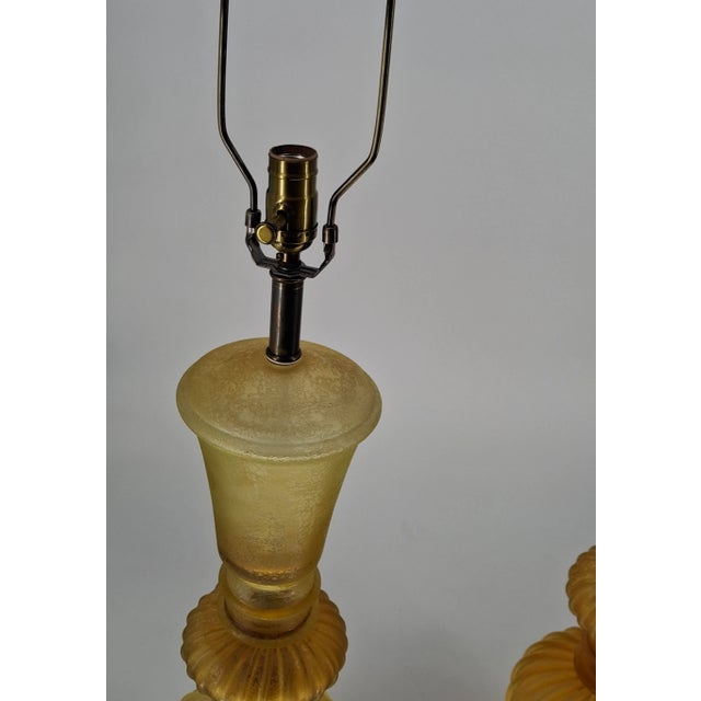Fantastic pair of mid century modern table lamps. In varying shades of yellow and amber (honey yellow acidato), these...