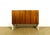 A walnut sideboard dating from the 1960s, featuring two storage doors with shelves. walnut doors, white painted frame....