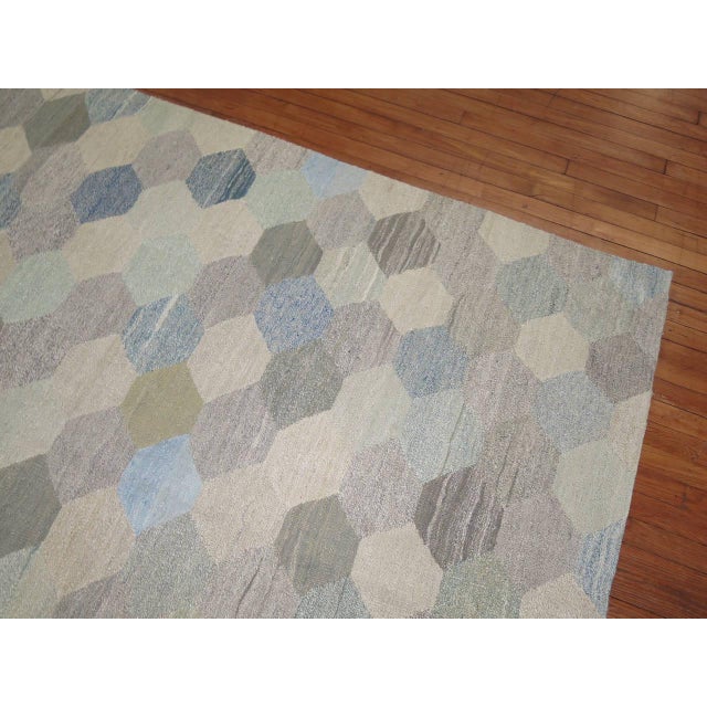 A Swedish influenced handmade room size Turkish Kilim from the late 20th century. Accents in white, blue and gray....