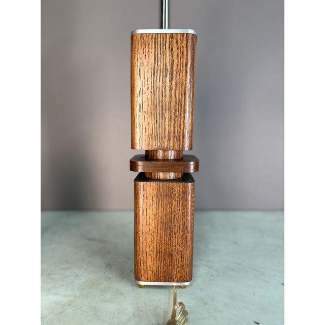 Gorgeous real wood grain. Rounded Sculptural wood blocks on lifted pegs. Silver accents in the base, lid and stem. Corded...
