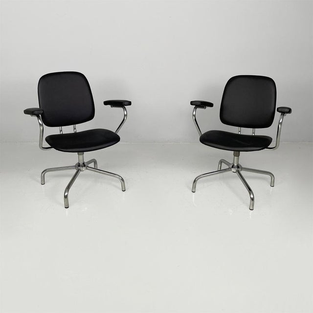 Italian modern swivel office chairs in steel and faux leather, 1960s Pair of swivel office chairs with a steel frame. The...