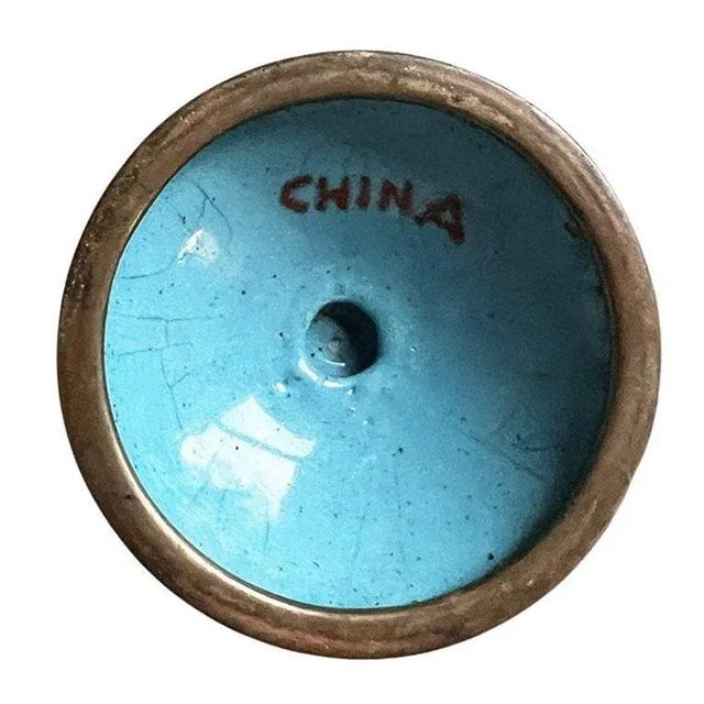 A petite cloisonne bud vase in white with a floral motif. This small vase is perfect for one or two stems of your favorite...