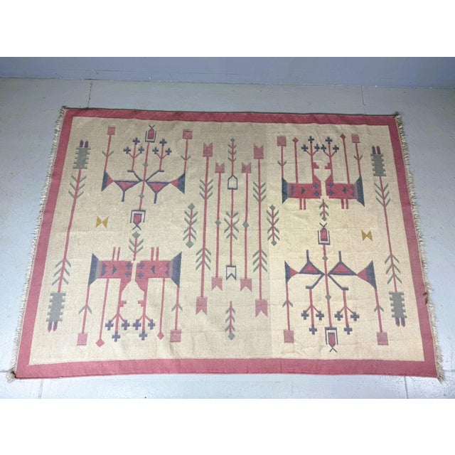 Authentic vintage kilim rug produced in Poland in the 1970s. This striking piece features a bold geometric and folkloric...